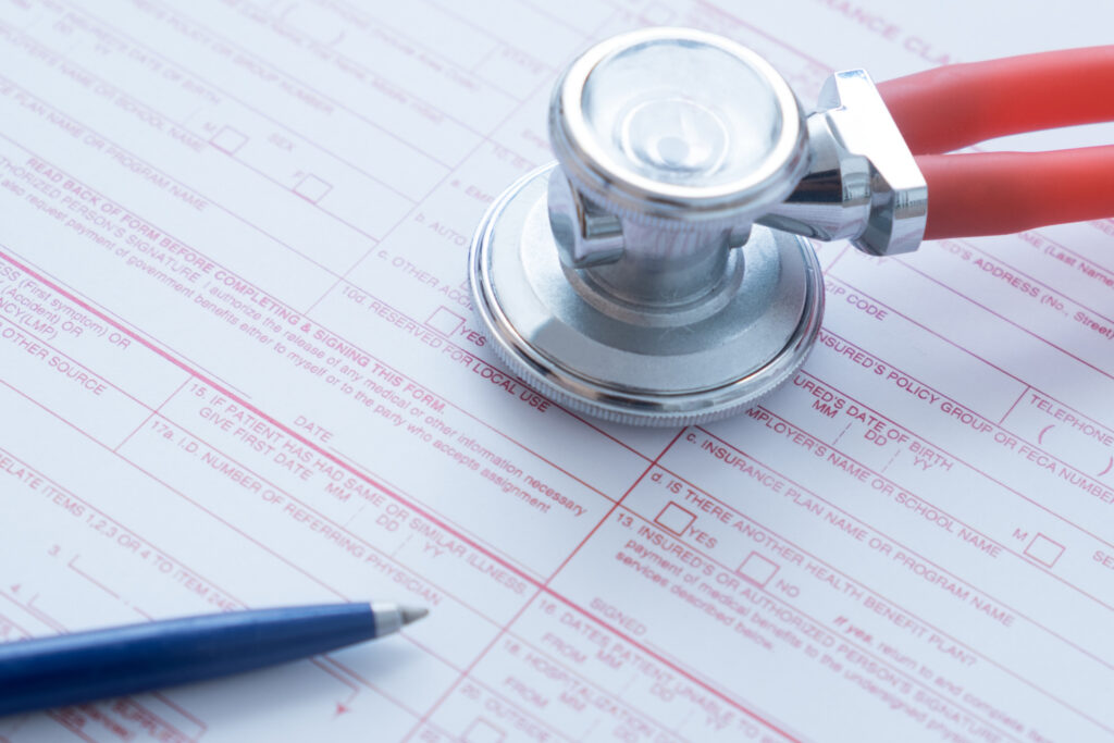 medical paperwork with a stethoscope and a pen